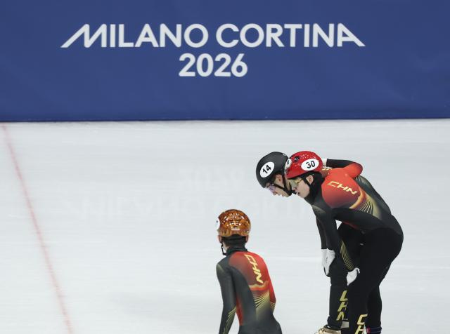 (260216) -- MILAN, Feb. 16, 2026 (Xinhua) -- Liu Shaoang (C), Zhang Bohao (L) and Lin Xiaojun of China react after the short track speed skating men's 5000m relay semifinal at the Milan-Cortina 2026 Olympic Winter Games in Milan, Italy, Feb. 16, 2026. (Xinhua/Li Ming)