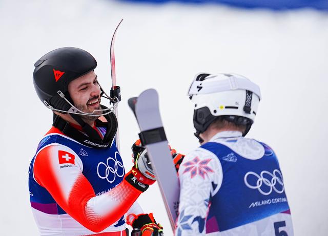 (260216) -- BORMIO, Feb. 16, 2026 (Xinhua) -- Gold medalist Loic Meillard (L) of Switzerland shakes hands with bronze medalist Henrik Kristoffersen of Norway after the alpine skiing men's slalom event at the Milan-Cortina 2026 Olympic Winter Games in Bormio, Italy, Feb. 16, 2026. (Xinhua/Yan Linyun)