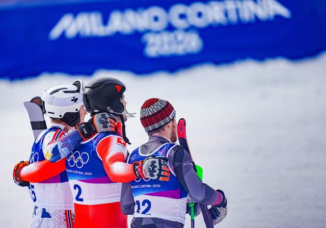 (260216) -- BORMIO, Feb. 16, 2026 (Xinhua) -- Gold medalist Loic Meillard (C) of Switzerland, silver medalist Fabio Gstrein (R) of Austria, and bronze medalist Henrik Kristoffersen of Norway pose for photos after the alpine skiing men's slalom event at the Milan-Cortina 2026 Olympic Winter Games in Bormio, Italy, Feb. 16, 2026. (Xinhua/Yan Linyun)