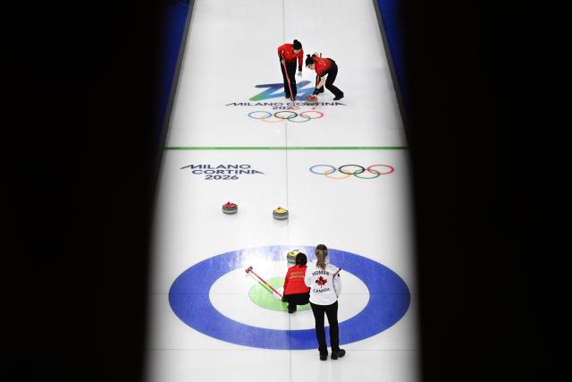 (260216) -- CORTINA D'AMPEZZO, Feb. 16, 2026 (Xinhua) -- Han Yu and Dong Ziqi (R) of China compete during the curling women round robin session 7 match between China and Canada at the 2026 Milan-Cortina Winter Olympics in Cortina, Italy, Feb. 16, 2026. (Xinhua/Lian Yi)