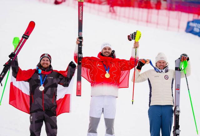 (260216) -- BORMIO, Feb. 16, 2026 (Xinhua) -- Gold medalist Loic Meillard (C) of Switzerland, silver medalist Fabio Gstrein (L) of Austria and bronze medalist Henrik Kristoffersen of Norway attend the awarding ceremony of the alpine skiing men's slalom event at the Milan-Cortina 2026 Olympic Winter Games in Bormio, Italy, Feb. 16, 2026. (Xinhua/Yan Linyun)