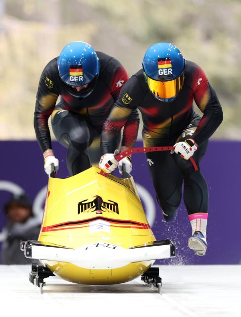 (260216) -- CORTINA D'AMPEZZO, Feb. 16, 2026 (Xinhua) -- Francesco Friedrich/Alexander Schuller of Germany compete during the bobsleigh 2-man heat 1 at the 2026 Milan-Cortina Winter Olympics in Cortina, Italy, Feb. 15, 2026. (Xinhua/Ding Xu)
