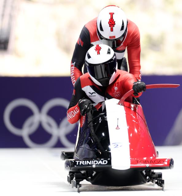 (260216) -- CORTINA D'AMPEZZO, Feb. 16, 2026 (Xinhua) -- Axel Brown/De Aundre John of Trinidad and Tobago compete during the bobsleigh 2-man heat 1 at the 2026 Milan-Cortina Winter Olympics in Cortina, Italy, Feb. 15, 2026. (Xinhua/Ding Xu)