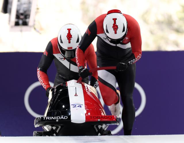 (260216) -- CORTINA D'AMPEZZO, Feb. 16, 2026 (Xinhua) -- Axel Brown/De Aundre John of Trinidad and Tobago compete during the bobsleigh 2-man heat 1 at the 2026 Milan-Cortina Winter Olympics in Cortina, Italy, Feb. 15, 2026. (Xinhua/Ding Xu)