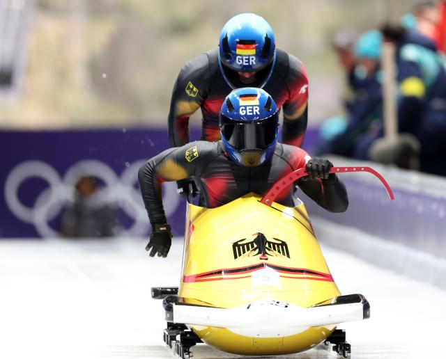 (260216) -- CORTINA D'AMPEZZO, Feb. 16, 2026 (Xinhua) -- Adam Ammour/Alexander Schaller of Germany compete during the bobsleigh 2-man heat 1 at the 2026 Milan-Cortina Winter Olympics in Cortina, Italy, Feb. 15, 2026. (Xinhua/Ding Xu)