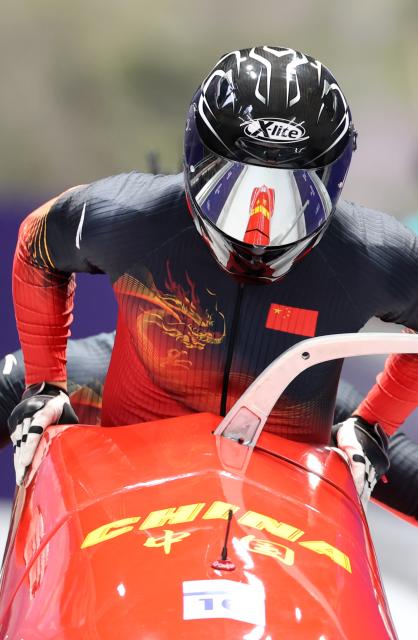 (260216) -- CORTINA D'AMPEZZO, Feb. 16, 2026 (Xinhua) -- Sun Kaizhi/An Tai of China compete during the bobsleigh 2-man heat 1 at the 2026 Milan-Cortina Winter Olympics in Cortina, Italy, Feb. 15, 2026. (Xinhua/Ding Xu)