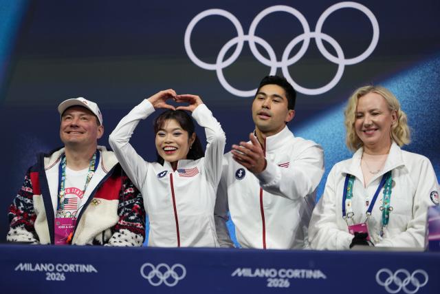 (260216) -- MILAN, Feb. 16, 2026 (Xinhua) -- Emily Chan (2nd L)/Spencer Akira Howe (2nd R) of the United States wait for their score during the figure skating pair skating free skating match at the Milan-Cortina 2026 Olympic Winter Games in Milan, Italy, Feb. 15, 2026. (Xinhua/Xue Yuge)