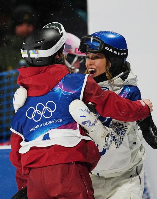 (260216) -- LIVIGNO, Feb. 16, 2026 (Xinhua) -- Gu Ailing (R) of China hugs Megan Oldham of Canada after the freestyle skiing women's freeski big air final at the Milan-Cortina 2026 Olympic Winter Games in Livigno, Italy, Feb. 16, 2026. (Xinhua/Hu Chao)