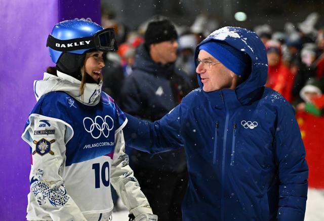 (260216) -- LIVIGNO, Feb. 16, 2026 (Xinhua) -- Gu Ailing (L) of China talks with International Olympic Committee (IOC) Honorary President for Life Thomas Bach after the freestyle skiing women's freeski big air final at the Milan-Cortina 2026 Olympic Winter Games in Livigno, Italy, Feb. 16, 2026. (Xinhua/Zhang Hongxiang)