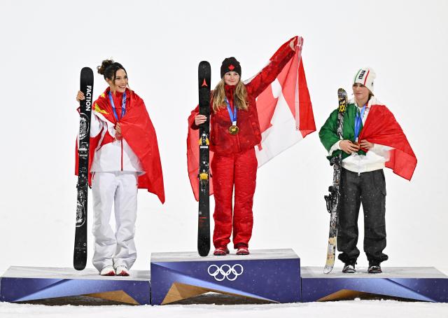 (260216) -- LIVIGNO, Feb. 16, 2026 (Xinhua) -- Gold medalist Megan Oldham (C) of Canada, silver medalist Gu Ailing (L) of China and bronze medalist Flora Tabanelli of Italy pose for photos during the awarding ceremony of the freestyle skiing women's freeski big air event at the Milan-Cortina 2026 Olympic Winter Games in Livigno, Italy, Feb. 16, 2026. (Xinhua/Zhang Hongxiang)
