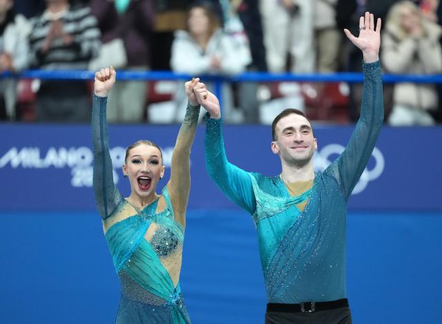 (260217) -- MILAN, Feb. 17, 2026 (Xinhua) -- Silver medalists Anastasiia Metelkina/Luka Berulava of Georgia wave to the spectators after standing on the podium during the victory ceremony for Figure Skating Pair Skating at the Milan-Cortina 2026 Olympic Winter Games in Milan, Italy, Feb. 16, 2026. (Xinhua/Xue Yuge)
