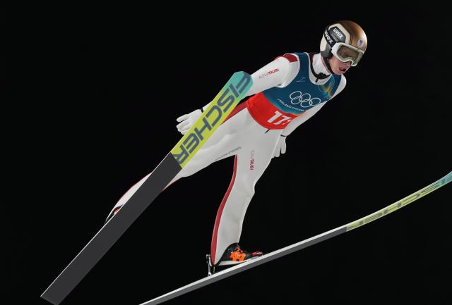 (260217) -- PREDAZZO, Feb. 17, 2026 (Xinhua) -- Jan Hoerl of Austria competes during the first round of the ski jumping men's super team event at the Milan-Cortina 2026 Olympic Winter Games in Predazzo, Italy, Feb. 16, 2026. (Xinhua/Meng Yongmin)