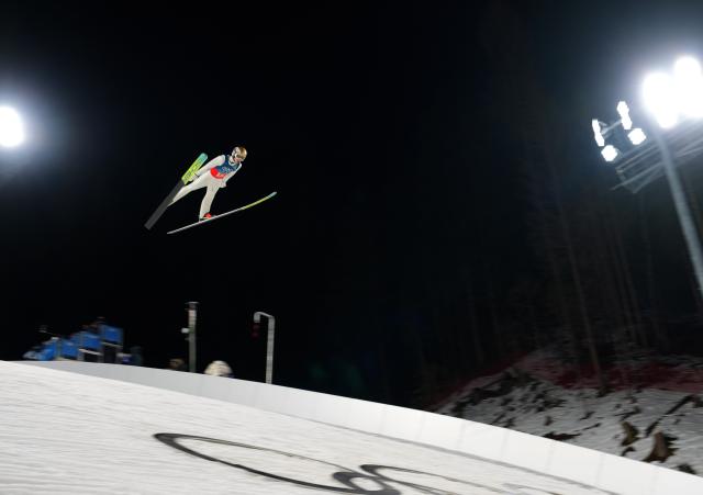 (260217) -- PREDAZZO, Feb. 17, 2026 (Xinhua) -- Jan Hoerl of Austria competes during the trial round of the ski jumping men's super team event at the Milan-Cortina 2026 Olympic Winter Games in Predazzo, Italy, Feb. 16, 2026. (Xinhua/Meng Yongmin)