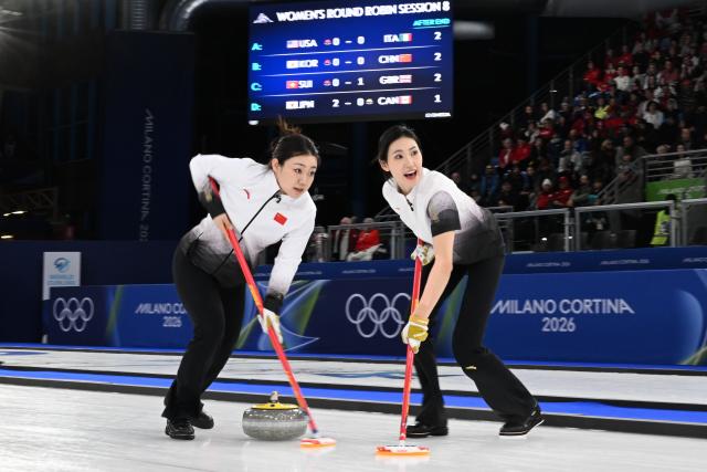 (260217) -- CORTINA D'AMPEZZO, Feb. 17, 2026 (Xinhua) -- Han Yu and Jiang Jiayi (R) of China compete during the curling women round robin session 8 match between China and South Korea at the Milan-Cortina 2026 Olympic Winter Games in Cortina, Italy, Feb. 16, 2026. (Xinhua/Lian Yi)