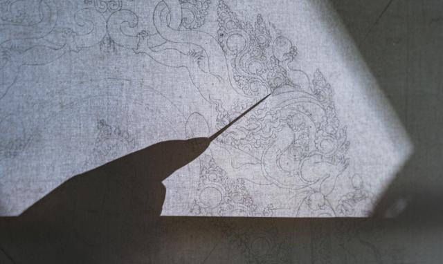 (260217) -- BEIJING, Feb. 17, 2026 (Xinhua) -- Norbu Sidar, a national-level inheritor of the Tibetan thangka, draws the details of a thangka at the Xizang Academy of Thangka in Lhasa, southwest China's Xizang Autonomous Region, Feb. 10, 2026. Thangka, renowned for its meticulous composition, vibrant colors, and profound cultural connotations, was listed among the first batch of China's national intangible cultural heritages in 2006. (Xinhua/Tenzin Nyida)