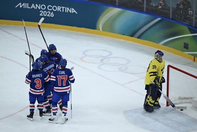 (260217) -- MILAN, Feb. 17, 2026 (Xinhua) -- Players of the United States celebrate during the Play-offs Semifinals match between the United States and Sweden of Ice hockey Women at the Milan-Cortina 2026 Olympic Winter Games in Milan, Italy, Feb. 16, 2026. (Xinhua/Zhang Haofu)