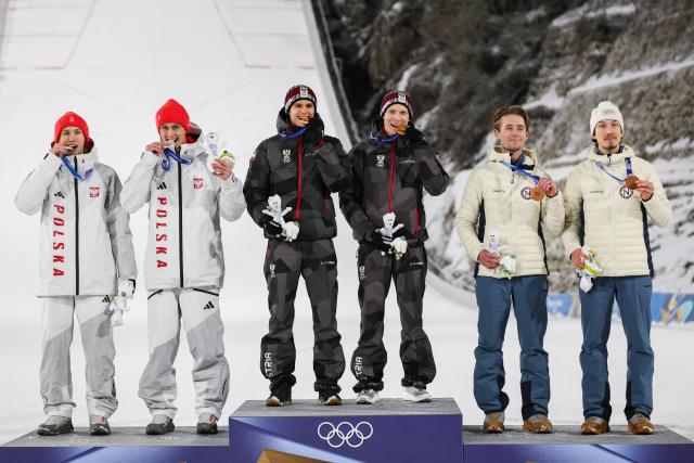 (260217) -- PREDAZZO, Feb. 17, 2026 (Xinhua) -- Gold medalist Team Austria (C), Silver medalist Team Poland (L) and Bronze medalist Team Norway pose on the podium after the ski jumping men's super team event at the Milan-Cortina 2026 Olympic Winter Games in Predazzo, Italy, Feb. 16, 2026. (Xinhua/Huang Wei)