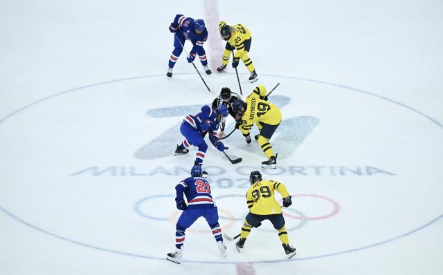 (260217) -- MILAN, Feb. 17, 2026 (Xinhua) -- Alex Carpenter (25) of the United States battles for the puck with Sweden's Sara Hjalmarsson (19) during the Play-offs Semifinals match between the United States and Sweden of Ice hockey Women at the Milan-Cortina 2026 Olympic Winter Games in Milan, Italy, Feb. 16, 2026. (Xinhua/Zhang Haofu)