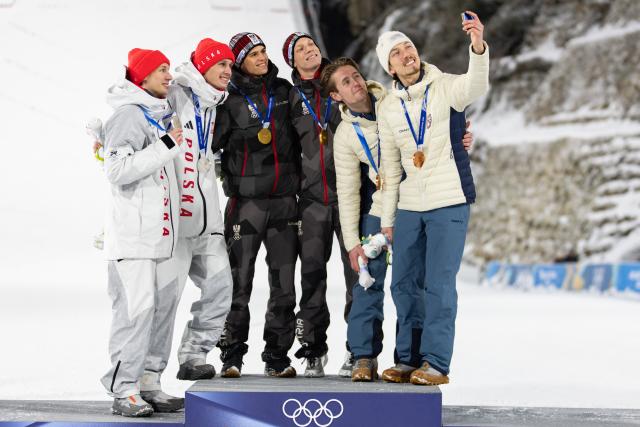 (260217) -- PREDAZZO, Feb. 17, 2026 (Xinhua) -- Gold medalist Team Austria (C), Silver medalist Team Poland (L) and Bronze medalist Team Norway pose for a selfie on the podium after the ski jumping men's super team event at the Milan-Cortina 2026 Olympic Winter Games in Predazzo, Italy, Feb. 16, 2026. (Xinhua/Huang Wei)