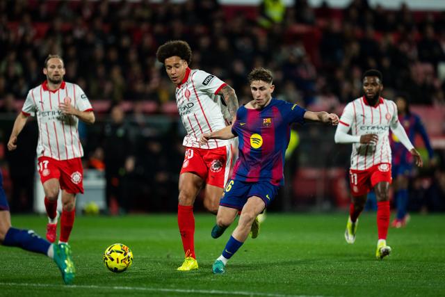 (260217) -- GIRONA, Feb. 17, 2026 (Xinhua) -- Fermin Lopez (R) of Barcelona vies with Axel Witsel of Girona during the La Liga football match between Girona FC and FC Barcelona in Girona, Spain, Feb. 16, 2026. (Photo by Joan Gosa/Xinhua)