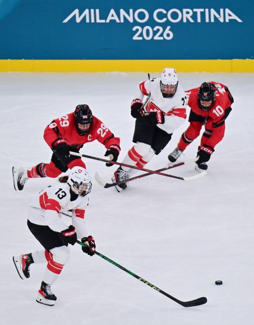 (260217) -- MILAN, Feb. 17, 2026 (Xinhua) -- Switzerland's Ivana Wey (13) chases for the puck during the Play-offs Semifinals match between Canada and Switzerland of Ice hockey Women at the Milan-Cortina 2026 Olympic Winter Games in Milan, Italy, Feb. 16, 2026. (Xinhua/Tao Xiyi)