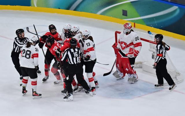 (260217) -- MILAN, Feb. 17, 2026 (Xinhua) -- Canada's Marie-Philip Poulin(29) clashes with Switzerland's players during the Play-offs Semifinals match between Canada and Switzerland of Ice hockey Women at the Milan-Cortina 2026 Olympic Winter Games in Milan, Italy, Feb. 16, 2026. (Xinhua/Tao Xiyi)