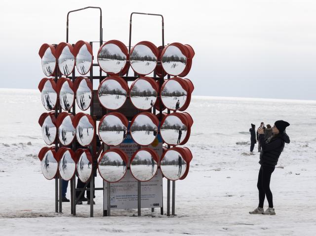 (260217) -- TORONTO, Feb. 17, 2026 (Xinhua) -- A woman takes photos of an art installation at the public exhibition of the 2026 Winter Stations international design competition in Toronto, Canada, Feb. 16, 2026. Winter Stations is an international design competition held annually in Toronto. It provides a platform for designers to reimagine lifeguard stations as art installations. (Photo by Zou Zheng/Xinhua)