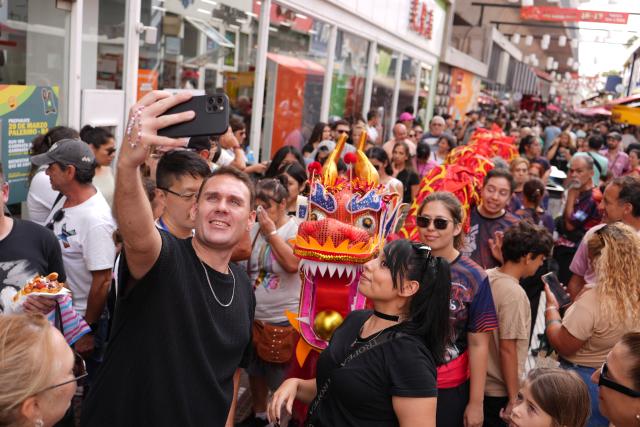 (260217) -- BUENOS AIRES, Feb. 17, 2026 (Xinhua) -- People attend a Spring Festival celebration in the Chinatown in Buenos Aires, capital of Argentina, Feb. 16, 2026. The event kicked off on Monday, featuring dragon and lion dances, traditional Chinese dance performances, as well as cultural experience activities such as martial arts and calligraphy. (Xinhua/Zhang Duo)