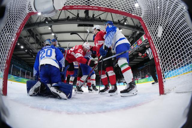 (260217) -- MILANMILAN, Feb. 17, 2026 (Xinhua) -- Players of both sides clash during the ice hockey men's qualification play-off round match between Switzerland and Italy at the Milan-Cortina 2026 Olympic Winter Games in Milan, Italy, Feb. 17, 2026. (Xinhua/Tao Xiyi)