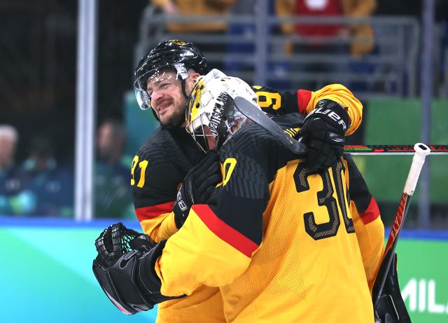 (260217) -- MILAN, Feb. 17, 2026 (Xinhua) -- Goalkeeper Philipp Grubauer (R) of Germany celebrates with teammate Moritz Muller after the ice hockey men's qualification play-off match between Germany and France at the Milan-Cortina 2026 Olympic Winter Games in Milan, Italy, Feb. 17, 2026. (Xinhua/Wang Kaiyan)