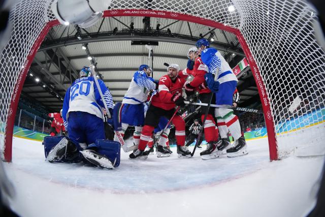 (260217) -- MILANMILAN, Feb. 17, 2026 (Xinhua) -- Players of both sides clash during the ice hockey men's qualification play-off round match between Switzerland and Italy at the Milan-Cortina 2026 Olympic Winter Games in Milan, Italy, Feb. 17, 2026. (Xinhua/Tao Xiyi)