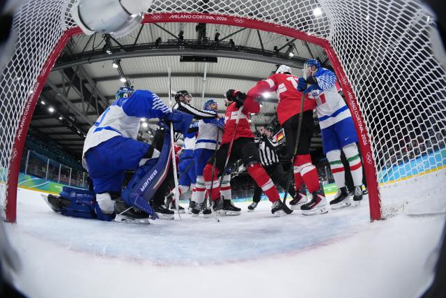 (260217) -- MILANMILAN, Feb. 17, 2026 (Xinhua) -- Players of both sides clash during the ice hockey men's qualification play-off round match between Switzerland and Italy at the Milan-Cortina 2026 Olympic Winter Games in Milan, Italy, Feb. 17, 2026. (Xinhua/Tao Xiyi)