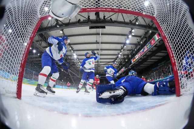 (260217) -- MILAN, Feb. 17, 2026 (Xinhua) -- Mats Frycklund (2nd L) of Italy competes during the ice hockey men's qualification play-off round match between Switzerland and Italy at the Milan-Cortina 2026 Olympic Winter Games in Milan, Italy, Feb. 17, 2026. (Xinhua/Tao Xiyi)