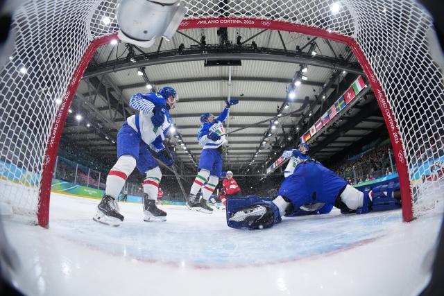 (260217) -- MILAN, Feb. 17, 2026 (Xinhua) -- Mats Frycklund (2nd L) of Italy competes during the ice hockey men's qualification play-off round match between Switzerland and Italy at the Milan-Cortina 2026 Olympic Winter Games in Milan, Italy, Feb. 17, 2026. (Xinhua/Tao Xiyi)