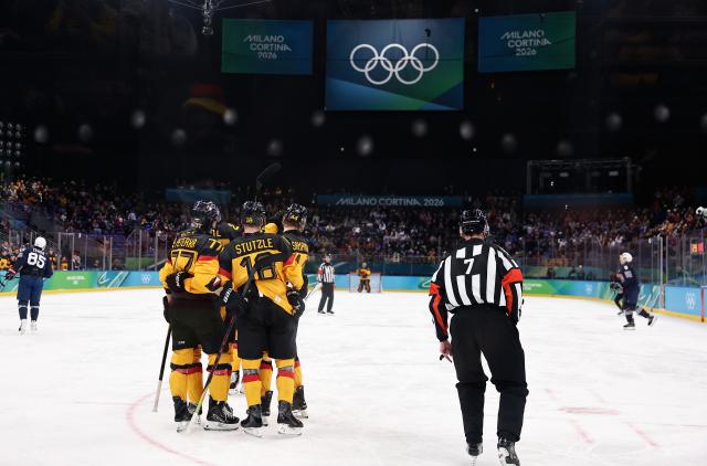 (260217) -- MILAN, Feb. 17, 2026 (Xinhua) -- Players of Germany react during the ice hockey men's qualification play-off match between Germany and France at the Milan-Cortina 2026 Olympic Winter Games in Milan, Italy, Feb. 17, 2026. (Xinhua/Wang Kaiyan)