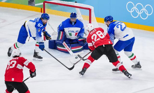 (260217) -- MILAN, Feb. 17, 2026 (Xinhua) -- Timo Meier (2nd R) of Switzerland competes with Mats Frycklund (2nd L) of Italy during the ice hockey men's qualification play-off round match between Switzerland and Italy at the Milan-Cortina 2026 Olympic Winter Games in Milan, Italy, Feb. 17, 2026. (Xinhua/Sun Fei)
