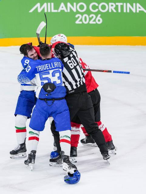 (260217) -- MILAN, Feb. 17, 2026 (Xinhua) -- Daniel Mantenuto (1st L) and Alex Trivellato (2nd L) of Italy clash with players of Switzerland during the ice hockey men's qualification play-off round match between Switzerland and Italy at the Milan-Cortina 2026 Olympic Winter Games in Milan, Italy, Feb. 17, 2026. (Xinhua/Sun Fei)