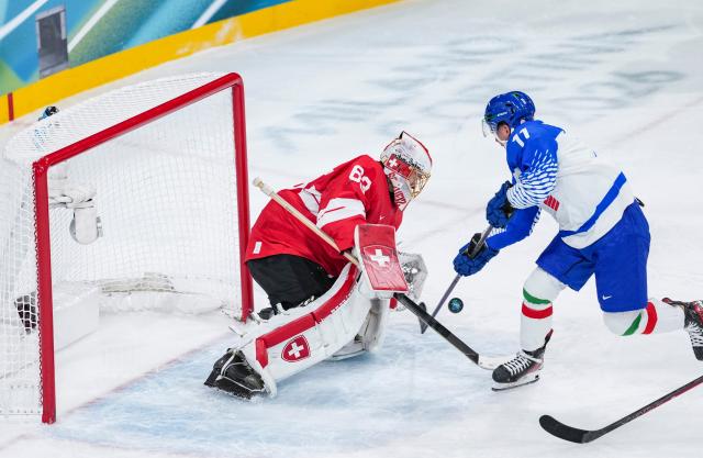 (260217) -- MILAN, Feb. 17, 2026 (Xinhua) -- Marco Zanetti (R) of Italy competes with Leonardo Genoni of Switzerland during the ice hockey men's qualification play-off round match between Switzerland and Italy at the Milan-Cortina 2026 Olympic Winter Games in Milan, Italy, Feb. 17, 2026. (Xinhua/Sun Fei)