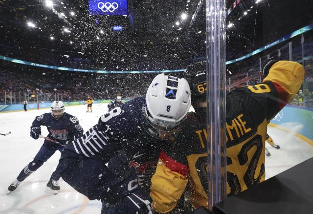 (260217) -- MILAN, Feb. 17, 2026 (Xinhua) -- Hugo Gallet (C) of France and Parker Tuomie (R) of Germany clash during the ice hockey men's qualification play-off match between Germany and France at the Milan-Cortina 2026 Olympic Winter Games in Milan, Italy, Feb. 17, 2026. (Xinhua/Wang Kaiyan)