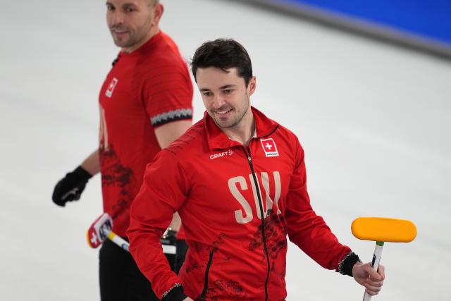 (260217) -- CORTINA D'AMPEZZO, Feb. 17, 2026 (Xinhua) -- Benoit Schwarz-van Berkel (R) of Switzerland reacts during the curling men's round robin session 9 match between Switzerland and Sweden at the 2026 Milan-Cortina Winter Olympics in Cortina, Italy, Feb. 17, 2026. (Xinhua/Li Gang)