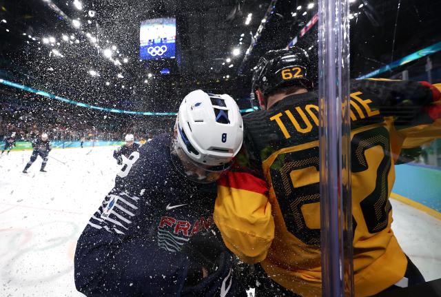(260217) -- MILAN, Feb. 17, 2026 (Xinhua) -- Hugo Gallet (L) of France and Parker Tuomie of Germany clash during the ice hockey men's qualification play-off match between Germany and France at the Milan-Cortina 2026 Olympic Winter Games in Milan, Italy, Feb. 17, 2026. (Xinhua/Wang Kaiyan)