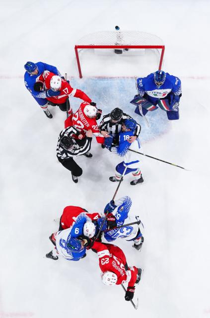 (260217) -- MILAN, Feb. 17, 2026 (Xinhua) -- Players of both sides clash during the ice hockey men's qualification play-off round match between Switzerland and Italy at the Milan-Cortina 2026 Olympic Winter Games in Milan, Italy, Feb. 17, 2026. (Xinhua/Tao Xiyi)