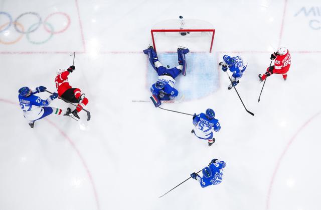 (260217) -- MILAN, Feb. 17, 2026 (Xinhua) -- Damian Clara (C, top) of Italy makes a save during the ice hockey men's qualification play-off round match between Switzerland and Italy at the Milan-Cortina 2026 Olympic Winter Games in Milan, Italy, Feb. 17, 2026. (Xinhua/Tao Xiyi)