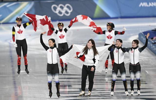 (260217) -- MILAN, Feb. 17, 2026 (Xinhua) -- Players of Canada and Japan celebrate after the speed skating women's team pursuit finals at the Milan-Cortina 2026 Olympic Winter Games in Milan, Italy, Feb. 17, 2026. (Xinhua/Wu Wei)