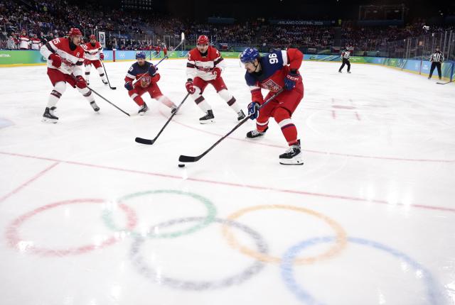 (260217) -- MILAN, Feb. 17, 2026 (Xinhua) -- David Tomasek (1st R) of the Czech Republic breaks through during the ice hockey men's qualification play-off match between the Czech Republic and Denmark at the Milan-Cortina 2026 Olympic Winter Games in Milan, Italy, Feb. 17, 2026. (Xinhua/Wang Kaiyan)