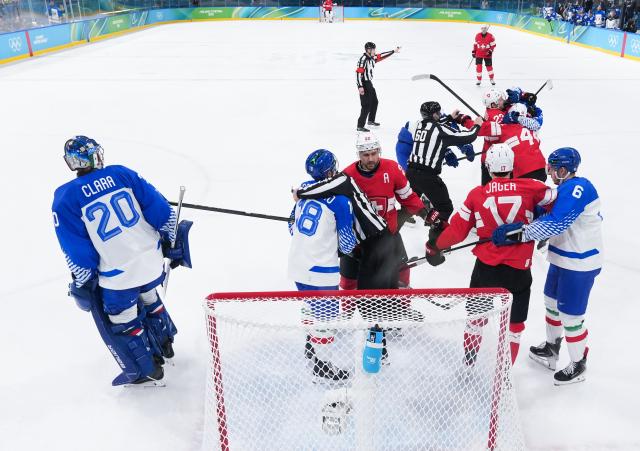 (260217) -- MILAN, Feb. 17, 2026 (Xinhua) -- Players of Switzerland and Italy fight with each other during the ice hockey men's qualification play-off match between Switzerland and Italy at the Milan-Cortina 2026 Olympic Winter Games in Milan, Italy, Feb. 17, 2026. (Xinhua/Tao Xiyi)
