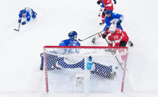 (260217) -- MILAN, Feb. 17, 2026 (Xinhua) -- Sandro Schmid (R) of Switzerland competes during the ice hockey men's qualification play-off match between Switzerland and Italy at the Milan-Cortina 2026 Olympic Winter Games in Milan, Italy, Feb. 17, 2026. (Xinhua/Tao Xiyi)