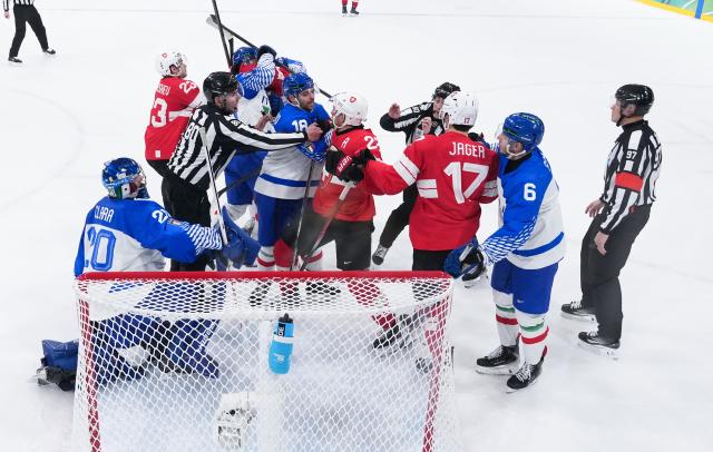 (260217) -- MILAN, Feb. 17, 2026 (Xinhua) -- Players of Switzerland and Italy fight with each other during the ice hockey men's qualification play-off match between Switzerland and Italy at the Milan-Cortina 2026 Olympic Winter Games in Milan, Italy, Feb. 17, 2026. (Xinhua/Tao Xiyi)
