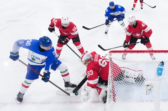 (260217) -- MILAN, Feb. 17, 2026 (Xinhua) -- Cristiano Digiacinto (L) of Italy competes during the ice hockey men's qualification play-off match between Switzerland and Italy at the Milan-Cortina 2026 Olympic Winter Games in Milan, Italy, Feb. 17, 2026. (Xinhua/Tao Xiyi)