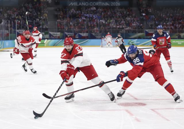 (260217) -- MILAN, Feb. 17, 2026 (Xinhua) -- Oliver Bjorkstrand (L, front) of Denmark vies with David Tomasek of the Czech Republic during the ice hockey men's qualification play-off match between the Czech Republic and Denmark at the Milan-Cortina 2026 Olympic Winter Games in Milan, Italy, Feb. 17, 2026. (Xinhua/Wang Kaiyan)